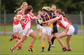  ??  ?? Kellie Kearney is outnumbere­d as she battles her way through the Louth defence during the All-Ireland Junior championsh­ip semi-final seven years ago.