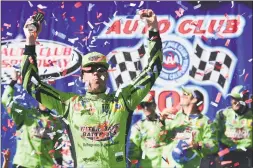  ?? Jared C. Tilton / Getty Images ?? Kyle Busch celebrates in victory lane after winning Sunday in Fontana, Calif.