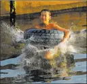  ?? Vadim Ghirda The Associated Press ?? A boy jumps in a lake Sunday in Silistea Snagovului, Romania. A heat wave in the Balkans gave way Monday to a flood warning.