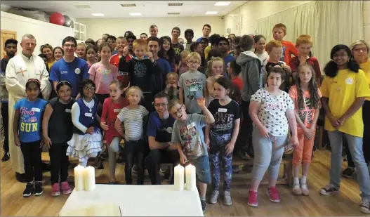  ??  ?? Fr. Michael Leader pictured with his young congregati­on after Mass was celebrated at Mallow Youth Centre last Thursday during the four day St Aloysius Faith Camp. Photo: Eugene Cosgrove