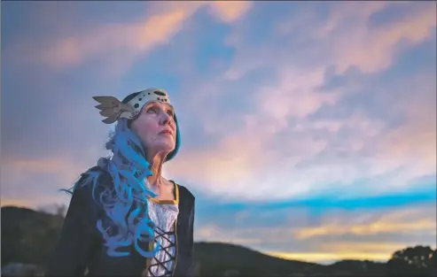  ??  ?? Taos Children’s Theatre Director Karen Thibodeau stands for a portrait Sunday (Dec. 20) outside her Taos home. Wearing a crown by Rose Gottschau, Thibodeau is dressed as the Atlantean Queen Mother from ‘Shell of Aphrodite,’ which is Taos Children’s Theatre ZOOM movie that premieres in January.