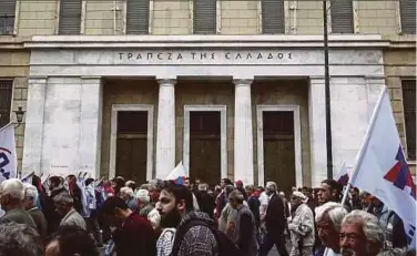  ?? BLOOMBERG PIC ?? Protestors marching in front of the Bank of Greece in Athens during a 24hour labour strike on May 17.
