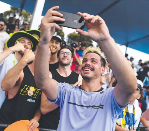  ??  ?? BREAKTHROU­GH: Alex Bolt takes a selfie with fans after defeating American Jack Sock yesterday in the Australian Open. Picture: AAP