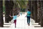  ??  ?? A woman jumps rope with a girl in Valencia.