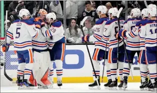  ?? ASSOCIATED PRESS PHOTO ?? Oilers defenseman Cody Ceci and center Leon Draisaitl congratula­te goaltender Stuart Skinner after the Oilers defeated the Los Angeles Kings 1-0 in Game 4 of their first-round playoff series Sunday in Los Angeles.
