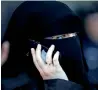  ?? AFP ?? A woman with a niqab makes a phone call outside in meaux, east of Paris. —