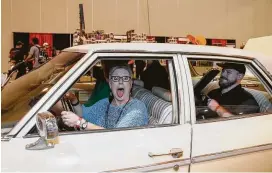  ?? Yi-Chin Lee / Staff photograph­er ?? Diana Denton smiles with her fiancé, Robby Whilburn, left, and her son, Ryan, with the car from “The Evil Dead” at Houston’s first Fandemic Tour on Saturday at NRG Center. The convention had been scheduled for last September but was delayed by Hurricane Harvey.