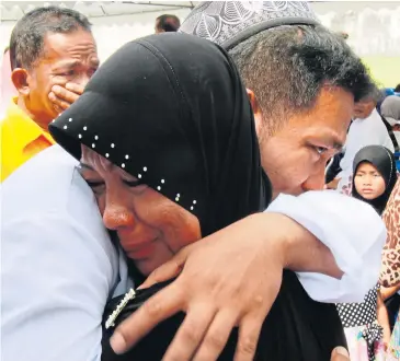  ?? TAWATCHAI KHEMGUMNER­D ?? An ethnic Malay Muslim woman embraces her relative, who was jailed in criminal cases involving southern violence, during a family day organised by the Southern Border Provinces Administra­tive Centre.