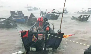  ?? RONG XIAO / FOR CHINA DAILY ?? Firefighte­rs use a boat to evacuate a stranded fisherman off Lianjiang county of Fujian province’s capital, Fuzhou, on Wednesday. Maria, the eighth typhoon this year, made landfall there in the morning.