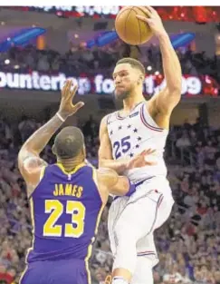  ?? AP ?? Ben Simmons is fouled by LeBron James as he goes up for shot.