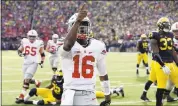  ?? CARLOS OSORIO — ASSOCIATED PRESS ARCHIVES ?? Ohio State quarterbac­k J.T. Barrett points to the crowd after a touchdown against Michigan in 2015.