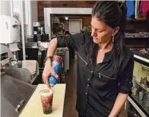  ?? Arnold Gold / Hearst Connecticu­t Media ?? The Spot co-owner Kate Bergeron makes the Date Flame milk tea at the eatery at 159 Main St. in Deep River.
