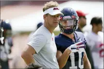  ?? ROGELIO V. SOLIS — THE ASSOCIATED PRESS ?? Mississipp­i football coach Lane Kiffin, left, and wide receiver John Rhys Plumlee (10) look at the camera during a morning NCAA college football practice on the Oxford, Miss., campus, Monday.