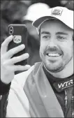  ?? AP ?? Fernando Alonso, of Spain, takes a selfie after winning last month’s IMSA 24-hour race at Florida’s Daytona Internatio­nal Speedway.