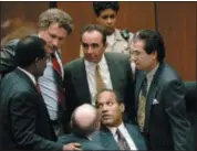  ?? SAM MIRCOVICH — THE ASSOCIATED PRESS FILE ?? O.J. Simpson is surrounded by his “Dream Team” defense attorneys from left, Johnnie L. Cochran Jr., Peter Neufeld, Robert Shapiro, Robert Kardashian, and Robert Blasier, seated at left, at the close of defense arguments in Los Angeles.