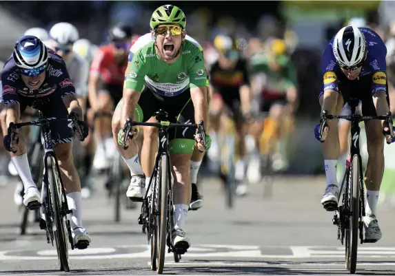  ?? Christophe Ena/AP ?? Mark Cavendish, in green, equalled the great Eddy Merckx’s record of 34 Tour de France stage wins with victory into Carcassonn­e yesterday