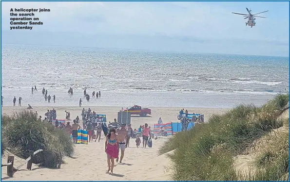  ?? Pictures: OWEN HUMPHREYS / PA ?? A helicopter joins the search operation on Camber Sands yesterday