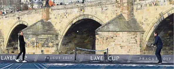  ??  ?? Easy does it: Roger Federer (right) playing tennis with Tomas Berdych on a pontoon on the Vltava River during an event to promote the Laver Cup in Prague Federer and Rafael Nadal (left) will be on the same side in the Europe team in the Laver Cup in...