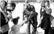  ?? PHOTO: REUTERS ?? A US Marine fists bumps a child evacuee at Kabul airport. According to Nato, around 18,000 have been flown out since Taliban captured the city