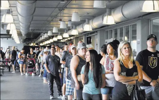  ?? Madelyn Rees Las Vegas Review-Journal ?? Golden Knights fans file in to buy merchandis­e from The Arsenal team store at City National Arena on May 21.