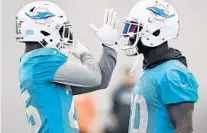  ?? TAIMY ALVAREZ/SUN SENTINEL ?? Dolphins Pro Bowl safety Reshad Jones, right, talks with cornerback Xavien Howard at the team’s training facility in Davie.