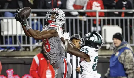  ?? JAY LAPRETE / AP ?? With Ohio State last season, wide receiver Marvin Harrison Jr. caught 67 passes for 1,211 yards and 14 touchdowns. He could be the first nonquarter­back chosen in this week’s NFL draft.