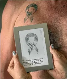  ?? JOHN KIRK-ANDERSON/STUFF ?? Nicki Ball wears a necklace inspired by a Japanese artstyle where breaks are highlighte­d and made beautiful. It is how she tries to frame her experience with cancer. Ball’s husband and two sons have matching tattoos of a ribbon. The tattoo has the date Nicki Ball received her diagnosis, and was meant to eventually feature the date she was cleared.