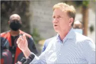  ?? Ned Gerard / Hearst Connecticu­t Media ?? Gov. Ned Lamont speaks during a news conference next to the mobile COVID-19 testing site set up outside Mount Aery Church, in Bridgeport on June 26.