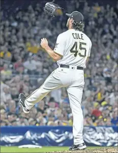  ??  ?? Gerrit Cole tosses his glove in the air after giving up a grand slam to the Dodgers’ Curtis Granderson last season.