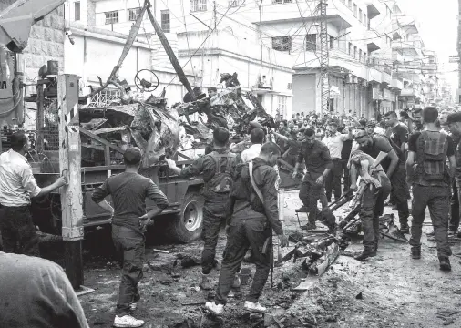  ??  ?? SYRIAN Kurdish security forces lift the wreckage of a rigged car which detonated outside the Syriac Orthodox Church of the Virgin Mary in the predominan­tly Christian neighbourh­ood of al-Wasti in the Kurdish-majority city of Qamishli in northeast Syria. There was no immediate claim for the attack, which Syrian state television said left several people wounded and cars damaged. Syria’s Kurds have led the US-backed fight in the war-torn country against the Islamic State group, which continues to claim deadly attacks despite its territoria­l defeat in March. AFP PHOTO