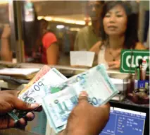  ?? — AFP photo ?? The ringgit is expected to remain stuck in a tight range as the market seeks more direction from key US economic data expected to be released in the coming week.