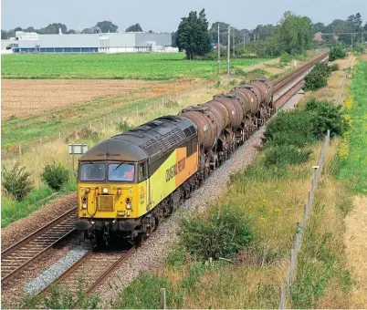  ??  ?? Colas ‘Grid' No. 56078 passes Ruskington (Lincolnshi­re) on August 11 heading the previous night's 6E98/21.54 departure from Aberdeen Waterloo to Spalding Up Sidings. Peter Foster