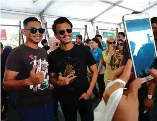  ??  ?? PENGUNJUNG mengambil gambar bersama Faizal Tahir di Bazar Terima Kasih, Melaka.