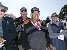  ?? LUKE E. MONTAVON/THE NEW MEXICAN ?? Eugene Conrad Rivera, 92, center, a World War II and Korea War veteran, was recognized by Gov. Michelle Lujan Grisham on Monday during the Veterans Day Ceremony at the Bataan Memorial.