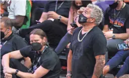  ?? MICHAEL CHOW/ARIZONA REPUBLIC ?? Restaurate­ur and TV personalit­y Guy Fieri watches Game 2 of the NBA Finals between the Phoenix Suns and the Milwaukee Bucks at Phoenix Suns Arena on July 8, 2021.