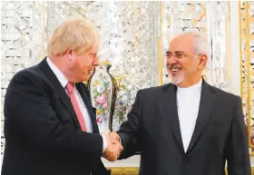  ?? Atta Kenare / AFP / Getty Images ?? British Foreign Secretary Boris Johnson (left) greets his Iranian counterpar­t, Mohammad Javad Zarif, in Tehran. Johnson is on a three-nation gulf tour.