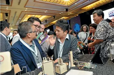  ??  ?? Attendees at the Microsoft Education Exchange in Singapore learn to use a micro:bit, a programmab­le mini computer being introduced to classrooms worldwide.