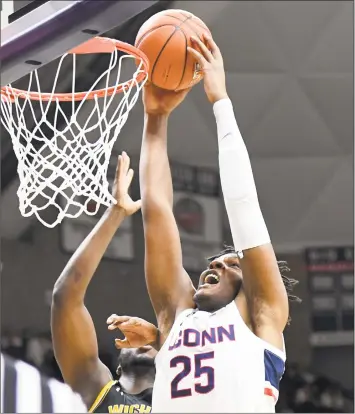  ?? Stephen Dunn / Associated Press ?? UConn’s Josh Carlton (25) goes up for a dunk against Wichita State on Saturday.
