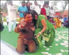  ??  ?? A video grab showing head warden Satwan Singh with a woman dancer at Jind Jail during a Holi programme on March 7.