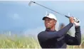  ??  ?? Tiger Woods tees off on the sixth holeduring­a practice round for the British Open Tuesday in Carnoustie, Scotland.