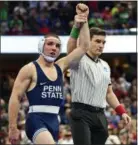  ?? DAVID DERMER - AP ?? Penn State’s Zain Retherford has his arm raised after defeating Lock Haven’s Ronald Perry during the 149-pound championsh­ip match of the NCAA Division I Wrestling Championsh­ips, Saturday, in Cleveland.