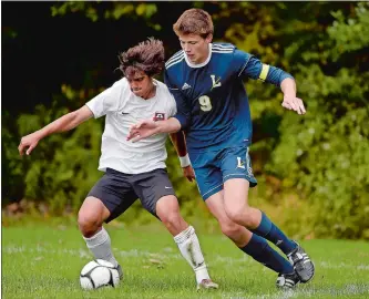  ?? SARAH GORDON/THE DAY ?? Fitch’s Eric Leuchner, left, has a step on Ledyard’s Xander Hutchins during Tuesday’s ECC Division II boys’ soccer battle at Colonel Ledyard Park. The Falcons moved a step closer to the program’s first ECC title with a 3-1 victory over the Colonels. Visit www.theday.com to view a photo gallery.