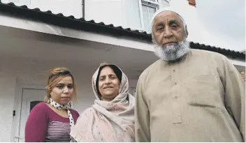  ??  ?? Cllr Azher Iqbal (left) and Bakhsh Elahi, Zanaib Bibi and daughter Tayyaba Bibi outside the home in Atkinson Street where the arson attack took place