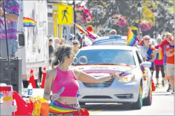  ?? TINA COMEAU ?? Smiles, colours, flags, signs, music and bubbles were all part of the Pride Parade.