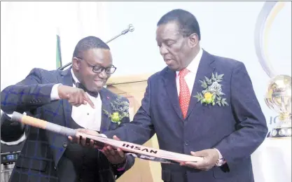  ??  ?? President Mnangagwa receives a cricket bat from Sport, Arts and Recreation Minister Kazembe Kazembe during a function to welcome the Internatio­nal Cricket Council World Cup qualifiers in Harare yesterday.- Picture by Munyaradzi Chamalimba