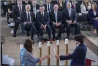  ?? Scott Applewhite) ?? President Joe Biden (left), Speaker of the House Mike Johnson, R-La., House Majority Leader Steve Scalise, R-La., House Minority Leader Hakeem Jeffries, D-N.Y., and former Speaker Nancy Pelosi, D-Calif., watch as children light candles to honor the memory of the 6 million Jews killed in the Holocaust during the annual Days of Remembranc­e ceremony at the Capitol Tuesday in Washington.
(AP/J.