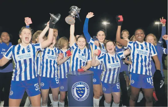  ?? Picture: Simon Roe ?? Brighton players celebrate with the trophy.