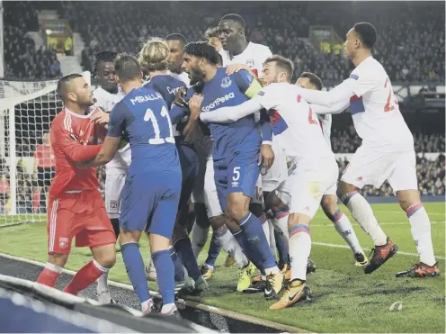  ??  ?? 0 Everton and Lyon players clash following a challenge by Ashley Williams, No 5, on Anthony Lopes.