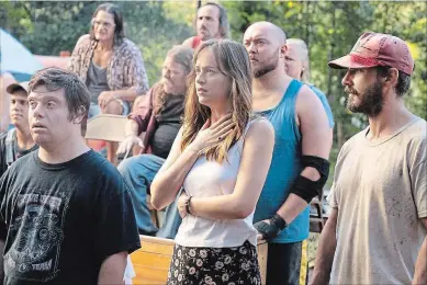  ?? NIGEL BLUCK ROADSIDE ATTRACTION­S/ARMORY FILMS ?? Zack Gottsagen, left, Dakota Johnson and Shia LaBeouf star in "The Peanut Butter Falcon."