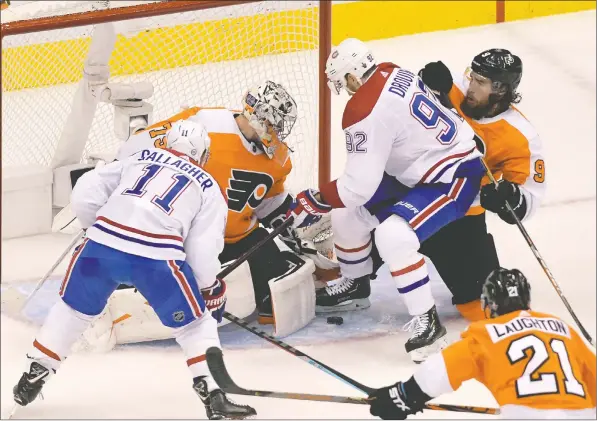  ?? — DAN HAMILTON/USA TODAY SPORTS ?? Flyers goaltender Carter Hart makes a save on Canadiens winger Jonathan Drouin as Flyers defenceman Ivan Provorov tries to tie him up during the second period of Game 1 of their Eastern Conference first-round series last night at Scotiabank Arena in Toronto.